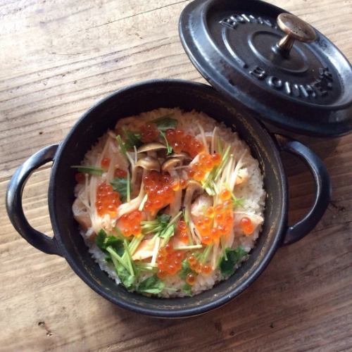 Rice cooked in a pot with salmon belly and salmon roe