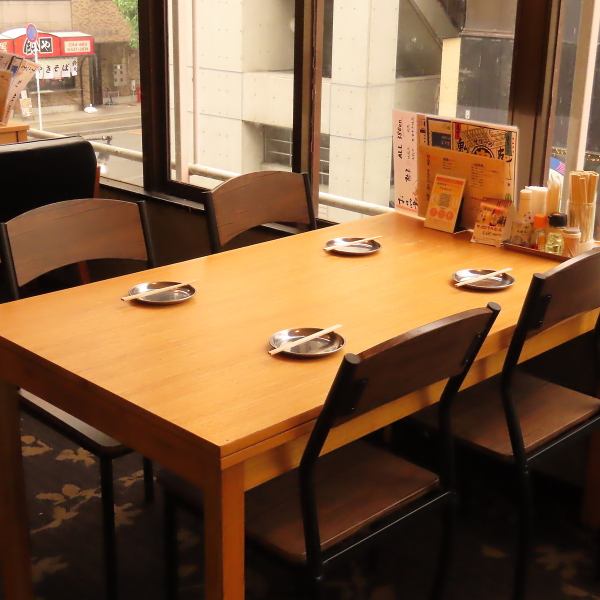 The bright and open interior features table seating.The furniture is simple and calm, creating a comfortable space.Plenty of natural light pours in through the windows, allowing you to relax and enjoy your meal.Enjoy a fun time with friends and colleagues.