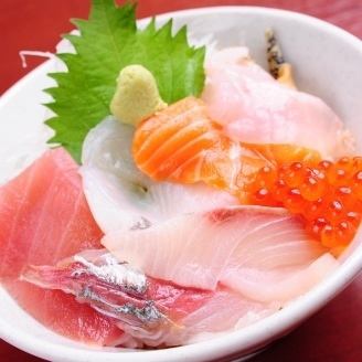 Bowl of rice topped with sashimi