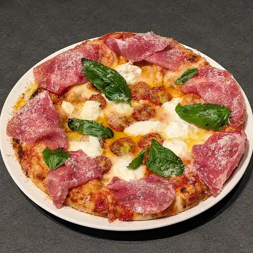 Margherita pizza with fresh mozzarella and prosciutto
