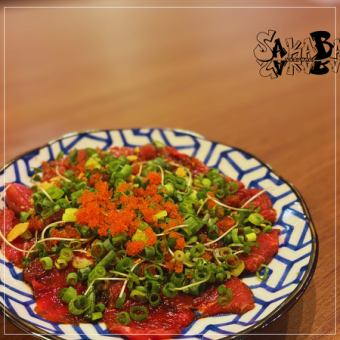 Horse sashimi covered in green onions