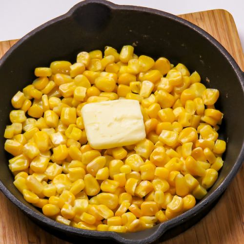 Hot corn and butter on a hot iron plate