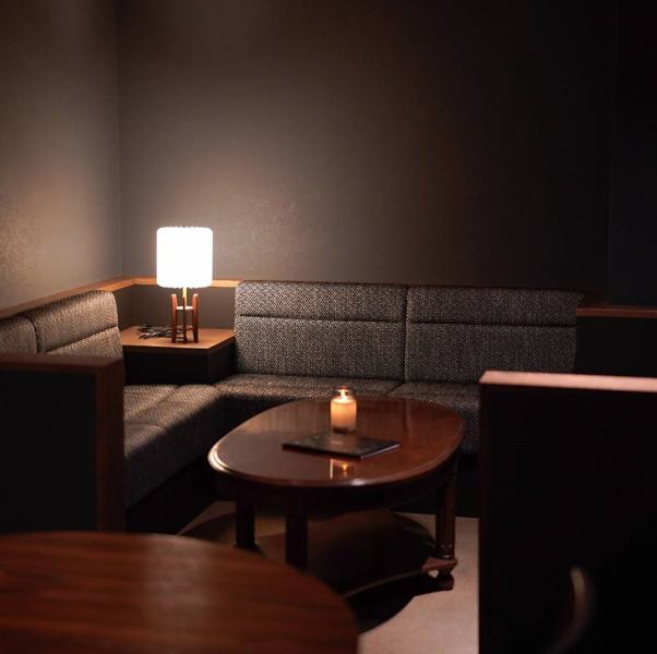 【ソファーで語らう】まるで半個室のようなソファー席は、間接照明の優しい灯りが心地良い、落ち着いた空間。ウイスキーを片手にテーブルを囲みながらご友人との語らいに最適です。