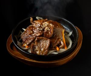 Wagyu beef off-cuts on a hot plate