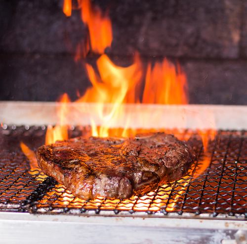 Meat dishes cooked on a wood-fire grill