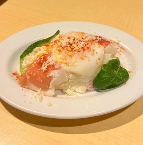 Homemade potato salad with soft-boiled egg and prosciutto