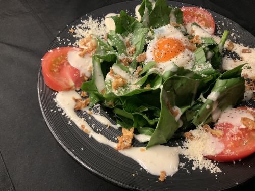 Caesar salad with soft-boiled eggs and spinach
