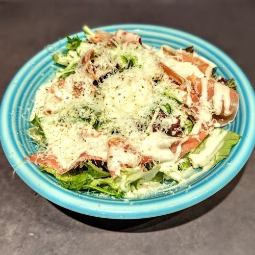 Caesar salad with soft-boiled egg and prosciutto