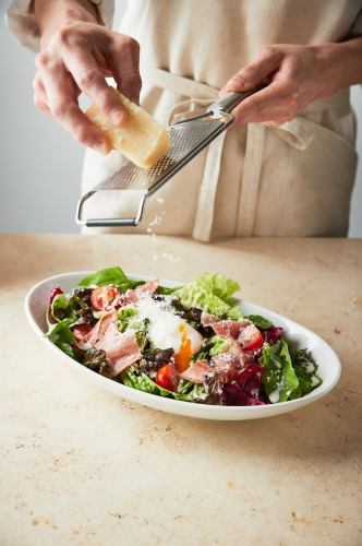 Caesar salad with raw ham and soft-boiled egg