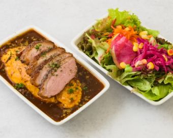 Omelette rice bento topped with sliced duck