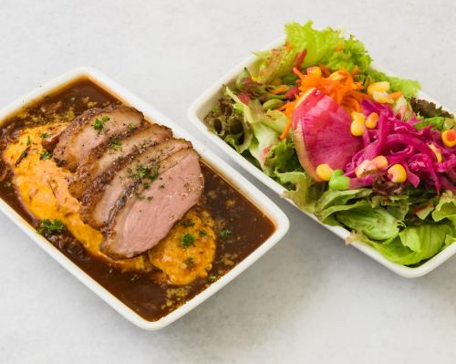 Omelette rice bento topped with sliced duck