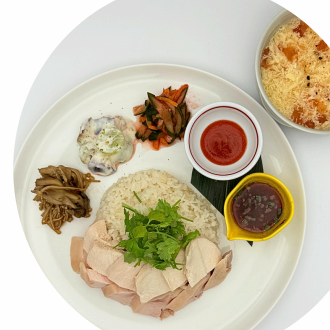 Healthy plate of steamed chicken and colorful vegetables