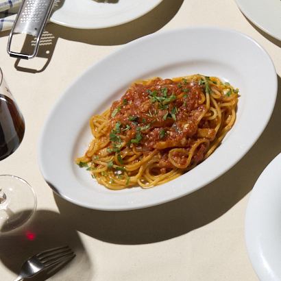 Tomato pasta with bacon and onion