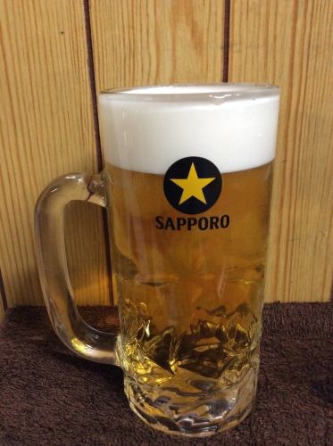 Large mug of Sapporo black label draft beer