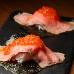 Salmon roe wrapped in meat sushi