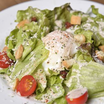 Caesar salad with soft-boiled egg and crushed bacon