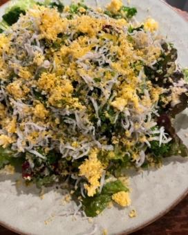Mimosa-style salad with kettle-fried whitebait, rape blossoms, and mimolette cheese
