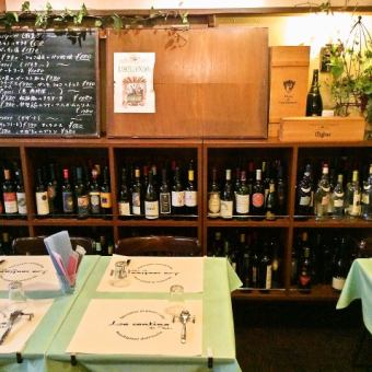 While looking at the table seating on the floor, the blackboard of the daily menu and the bottles of various wines.