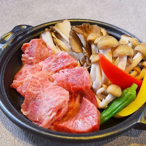 Grilled kelp aged Himi beef on a ceramic plate