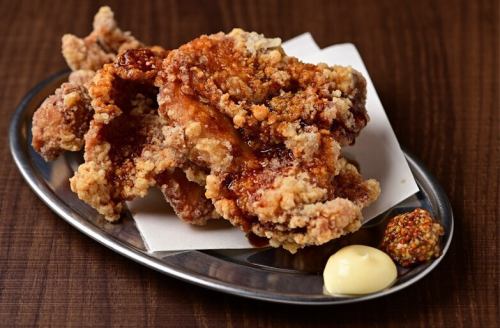 Two pieces of fried chicken with sauce