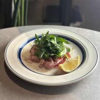 Marinated tuna and prosciutto with arugula carpaccio