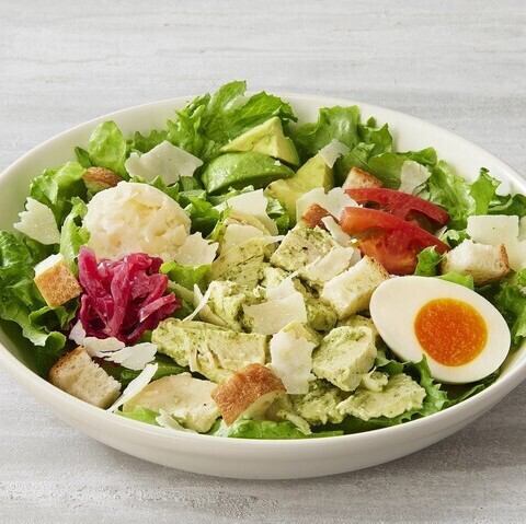 A salad with basil chicken and avocado, providing plenty of protein.