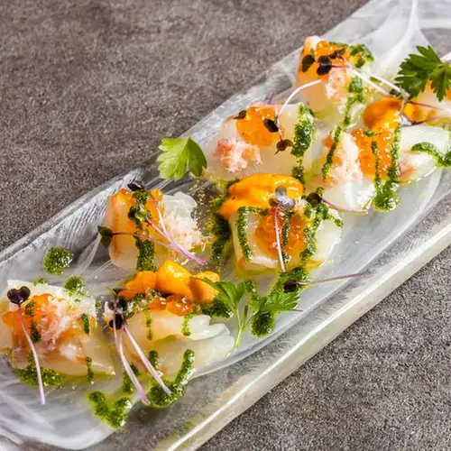 Sea bream carpaccio with sea urchin, salmon roe, and snow crab.