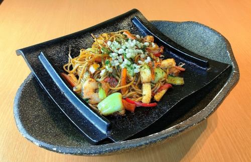 Yakisoba with seafood sauce served on a tile grill