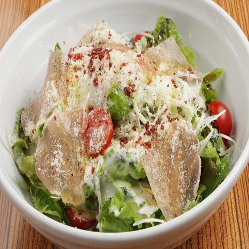Caesar salad with raw ham and warm egg