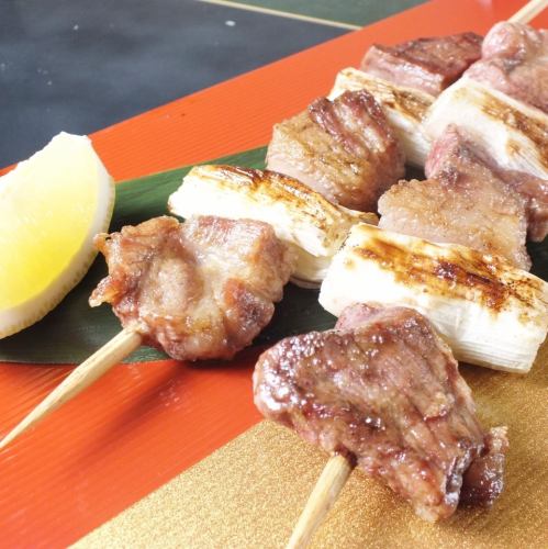 2 large skewers of TEA pork grilled with green onions