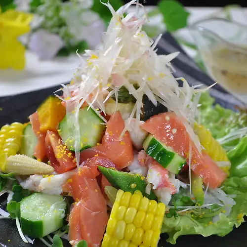 Colorful salad with summer vegetables and seafood