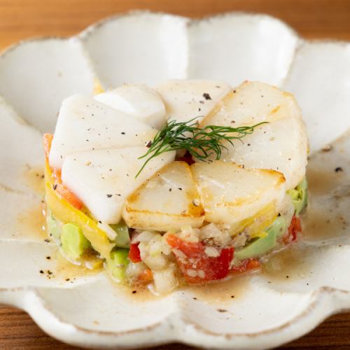 Tartar salad of colorful vegetables and smoked sardines in oil