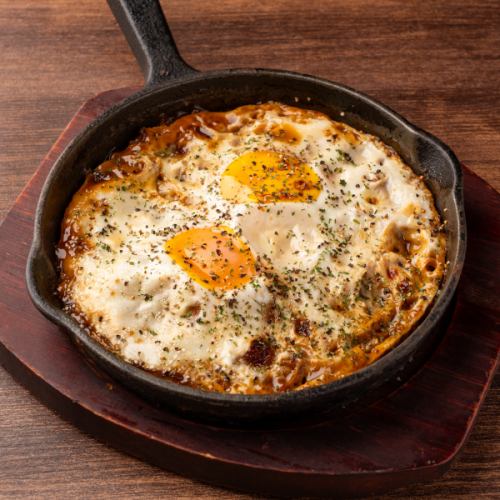 Grilled cheese meat with fried egg on top