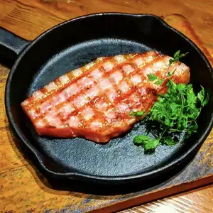 Thick-cut bacon grilled on a hot plate