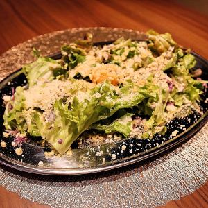 Caesar salad with fried egg and cheese