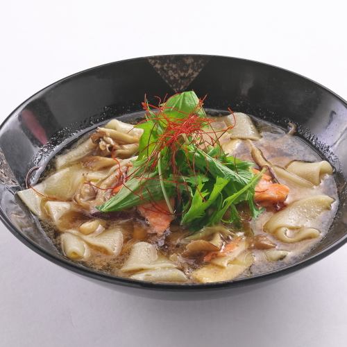 Spicy mushroom and salmon soup with wide noodles