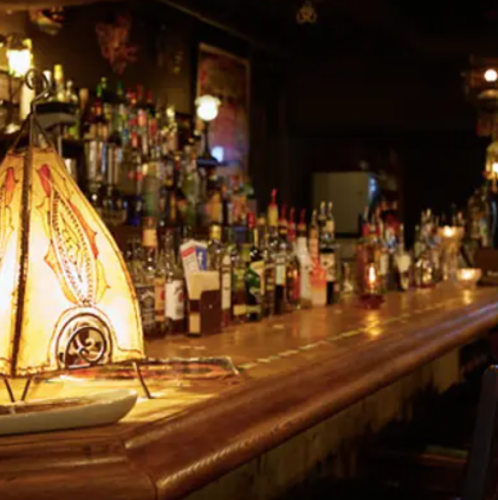 A full-fledged bar counter lit by candles