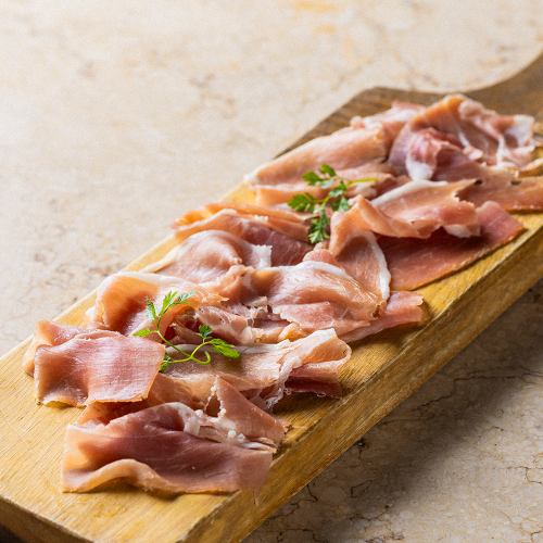 Freshly sliced prosciutto and grissini