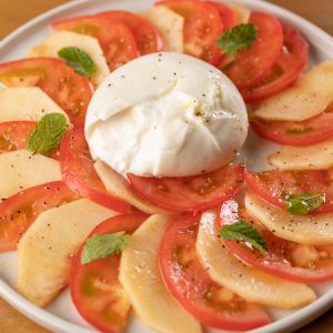 Caprese with seasonal fruits and tomato, burrata cheese