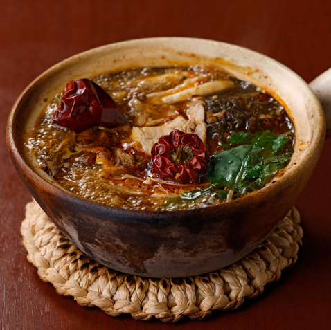 Fermented and spicy hot pot - Plenty of vegetables and mushrooms stewed in a spicy clay pot -