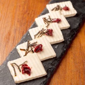 Cream cheese topped with plum and kelp