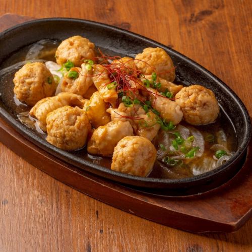 Meatballs and chicken skin grilled on an iron plate with sauce or salt sauce
