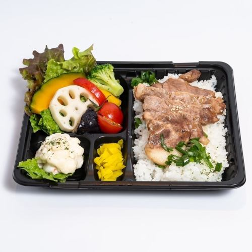 Thick-sliced ginger pork steak and healthy vegetables in a bento box