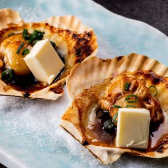 Two butter-grilled scallops in their shells