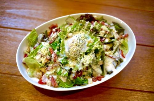 Caesar salad with warm egg and bacon
