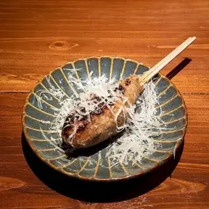 Lamb meatball skewers with shaved Pecorino cheese