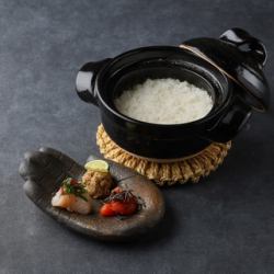 White rice cooked in an earthenware pot with 3 side dishes