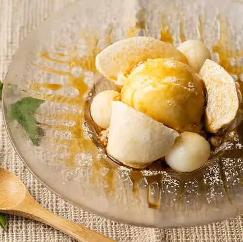 Sesame pudding and vanilla ice cream topped with brown sugar syrup and kinako powder
