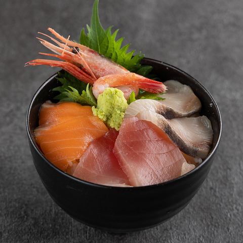 Bowl of rice topped with sashimi
