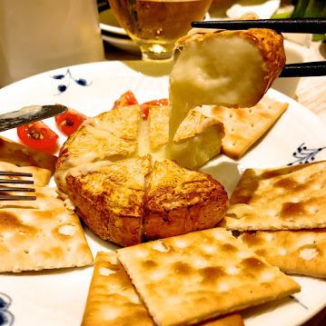 Whole happy camembert cheese with honey